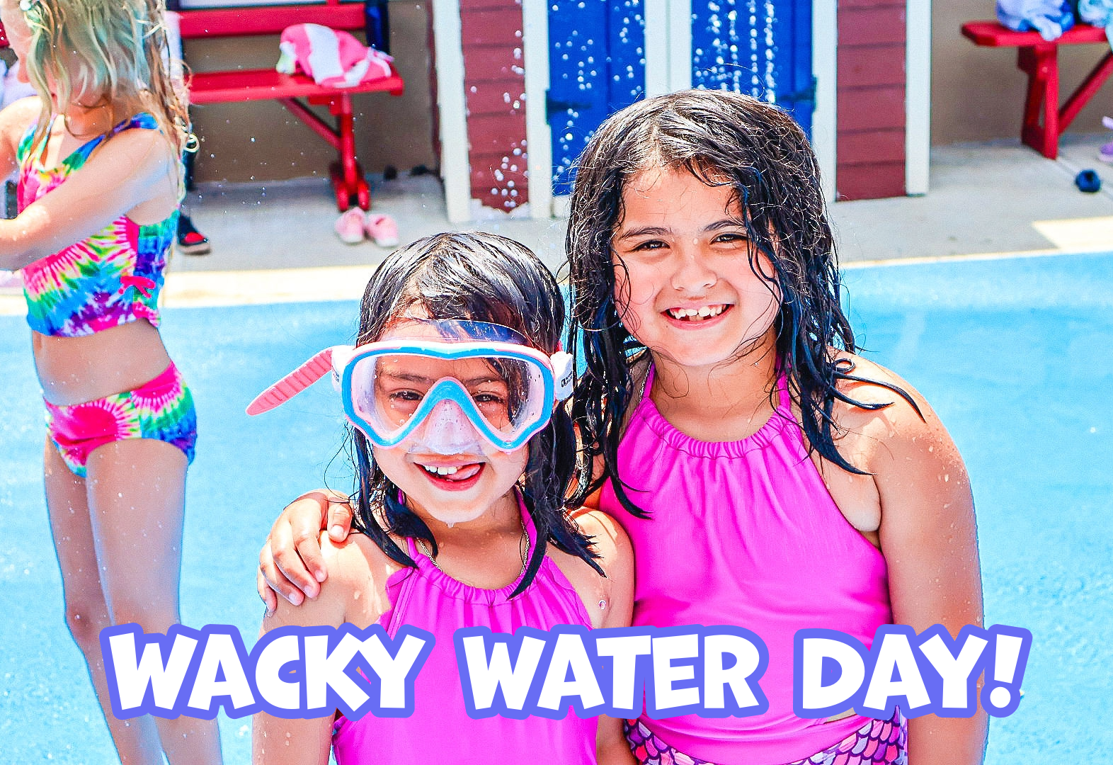 Two girls in pink swimsuits smile in a splash pad with "WACKY WATER DAY" text.