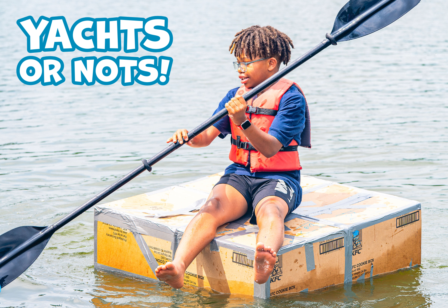 Person wearing a life jacket paddling a raft made of taped cardboard boxes on water with text YACHTS OR NOTS.