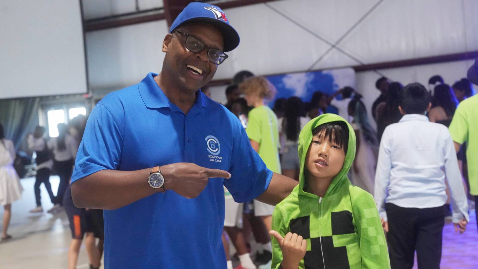 A man and woman in costumes pointing at something.